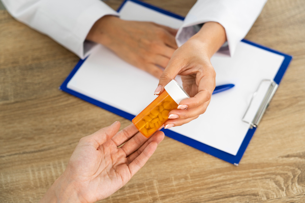 people holding pill bottle.