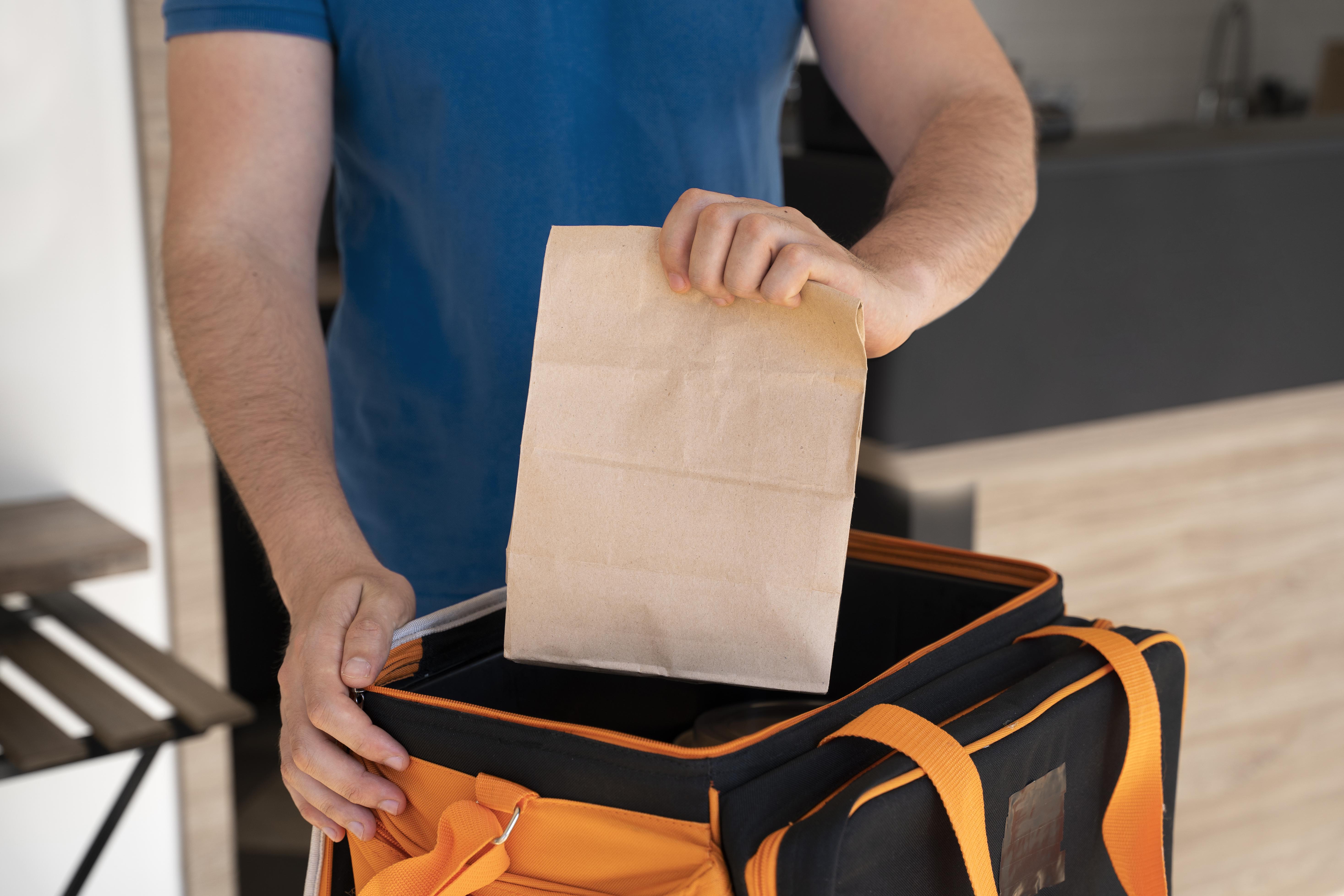 man holding paper bag